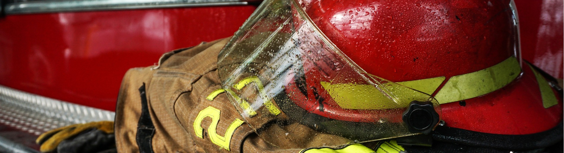 Firefighter's helmet and coat sitting on fire truck