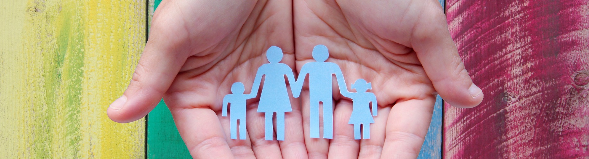 Hands holding paper family cutout