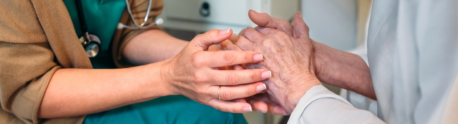 nurse and patient holding hands