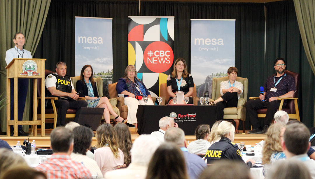 Panellists on stage looking into the crowd