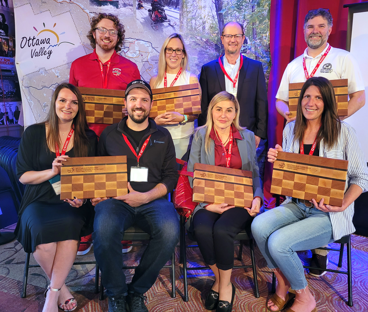 group of award winners with wooden plaque awards