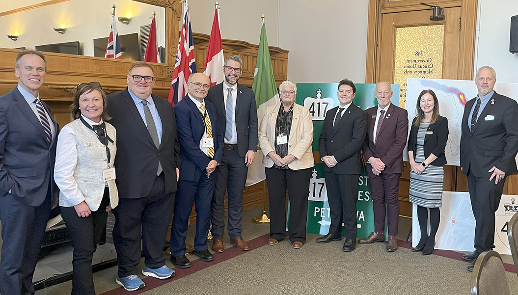 group of people standing in front of flags and banners