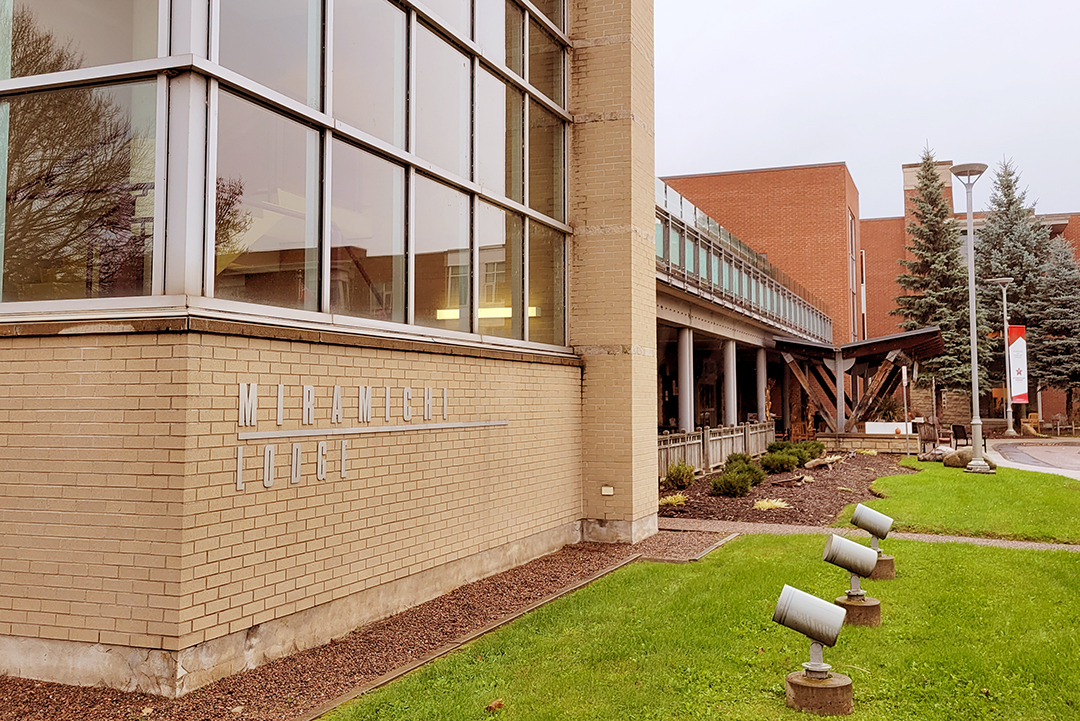 exterior short of a beige brick building - Miramichi Lodge long-term care home, from the corner looking towards the main entrance