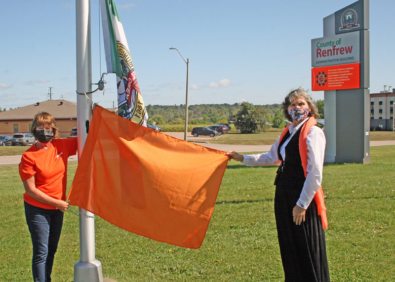 Warden Debbie Robinson and Chief Wendy Jocko raise an orange flag outside the County of Renfrew Administration building Warden Debbie Robinson and Chief Wendy Jocko raise an orange flag outside the County of Renfrew Administration building
